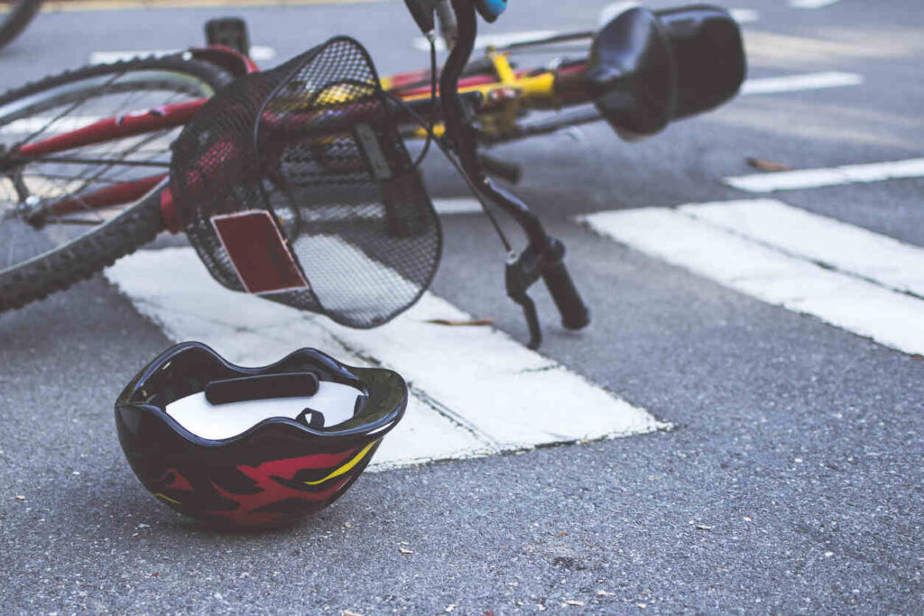 Helmet and bike lying on the road after hit and run accident crash