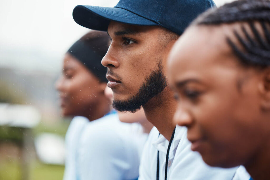 Close-up of focused student athletes, symbolizing their classification as employees.