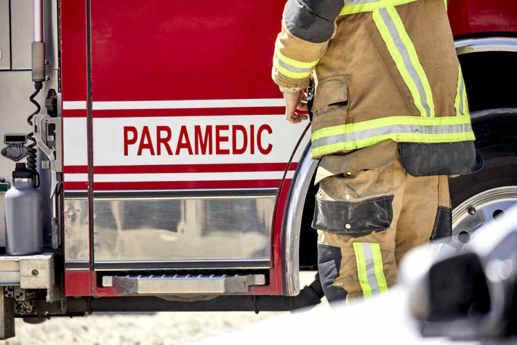 A paramedic stands by a fire truck after a Gaston County paramedic was killed while assisting a crash victim on I-95 in Florida.
