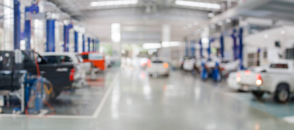 A busy auto shop with vehicles under service, highlighting the hands-on training opportunities for local students in North Mecklenburg.